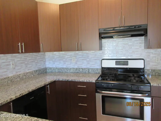 a stove top oven sitting inside of a kitchen
