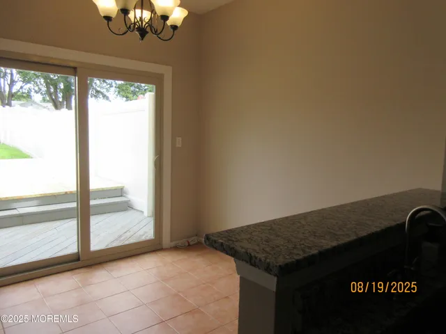 a view of a livingroom with wooden floor and a large window