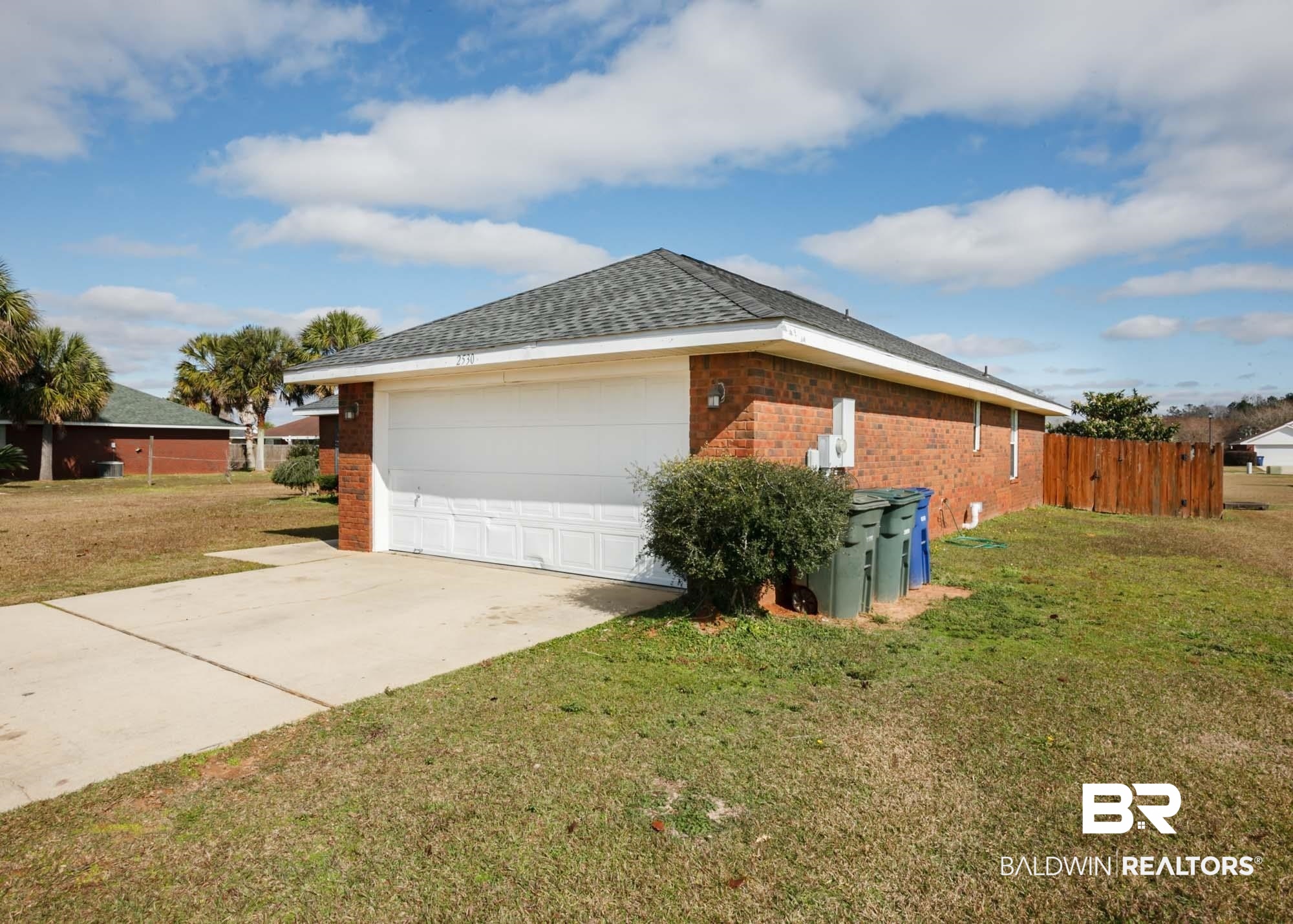 2530 Ashburn Lane Foley, AL 36535 - Photo 3 of 46 View of property exterior featuring a yard and a garage
