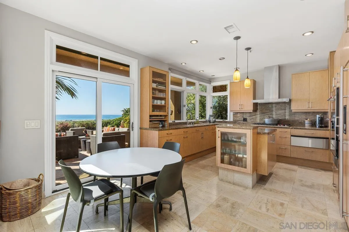 849 North Rios Avenue Solana Beach, CA 92075 - Photo 12 of 40 a kitchen with a table chairs stove and cabinets