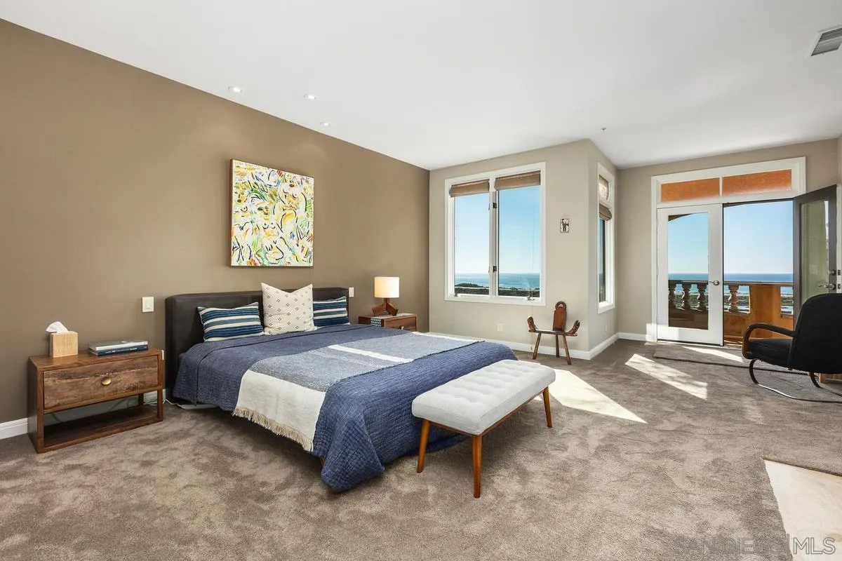 849 North Rios Avenue Solana Beach, CA 92075 - Photo 21 of 40 a spacious bedroom with a bed a table and chair