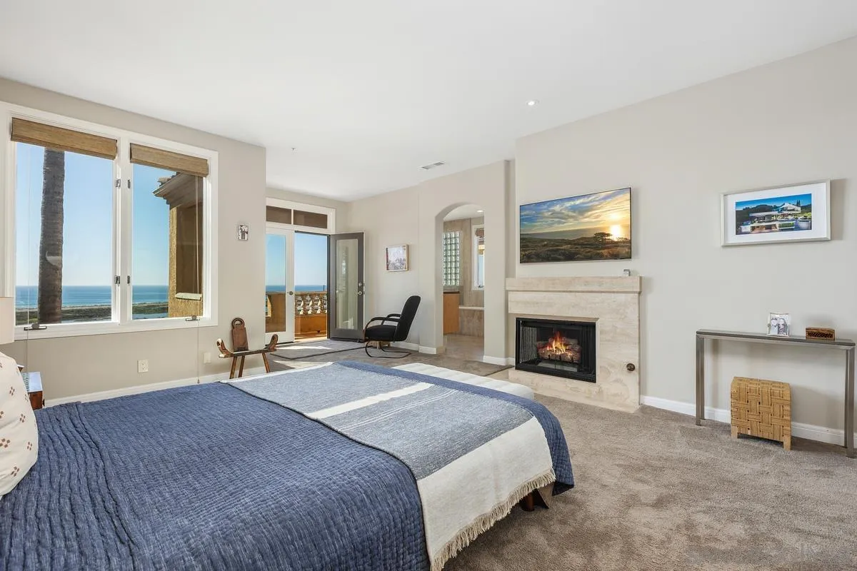 849 North Rios Avenue Solana Beach, CA 92075 - Photo 23 of 40 a spacious bedroom with a bed and a fireplace