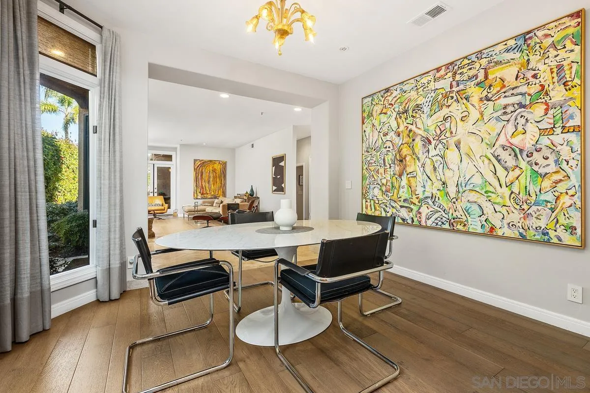 849 North Rios Avenue Solana Beach, CA 92075 - Photo 10 of 40 a dining room with wooden floor a chandelier a glass table and chairs