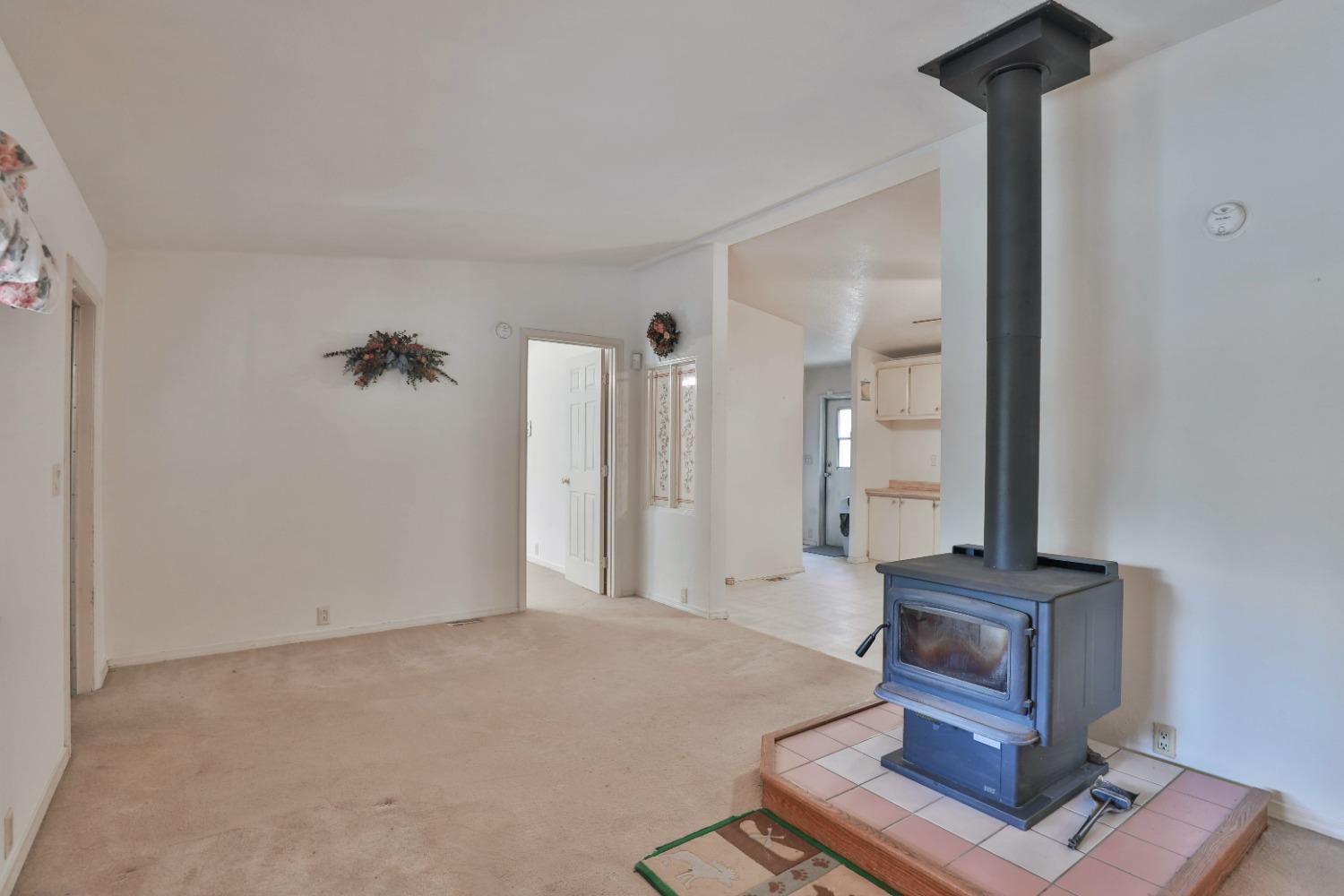 7277 Red Ant Road Somerset, CA 95684 - Photo 11 of 42 a view of a hallway with wooden floor and a cabinet