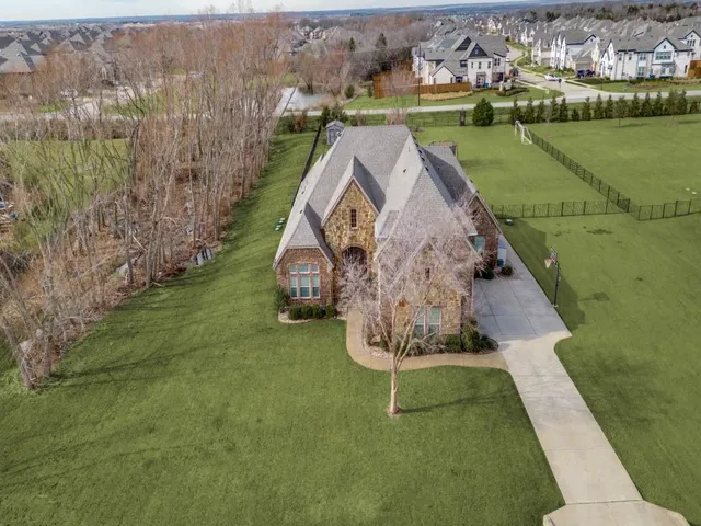 an aerial view of a house with a yard