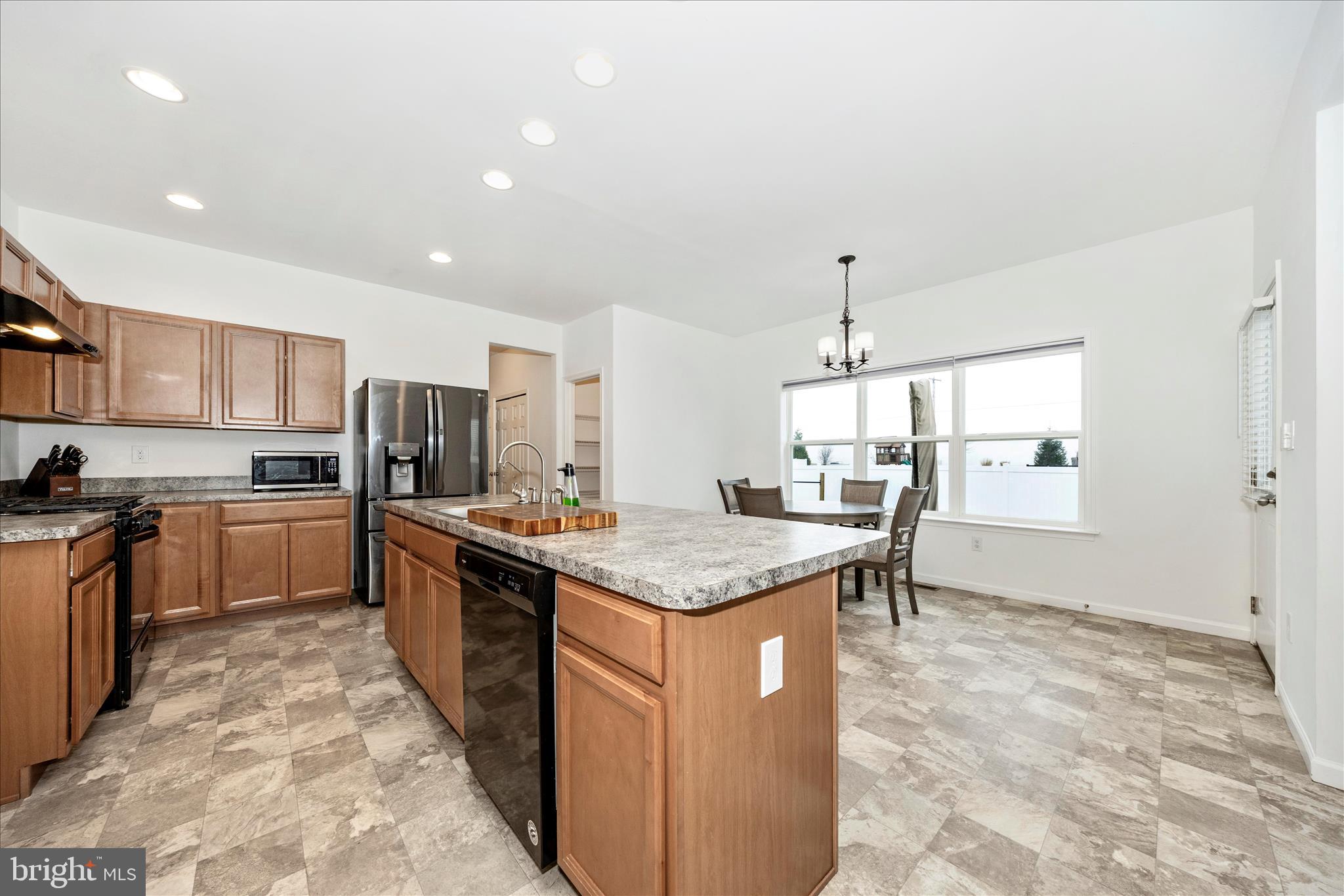 309 Eliza Road New Freedom, PA 17349 - Photo 11 of 57 a kitchen with stainless steel appliances granite countertop a sink stove and refrigerator