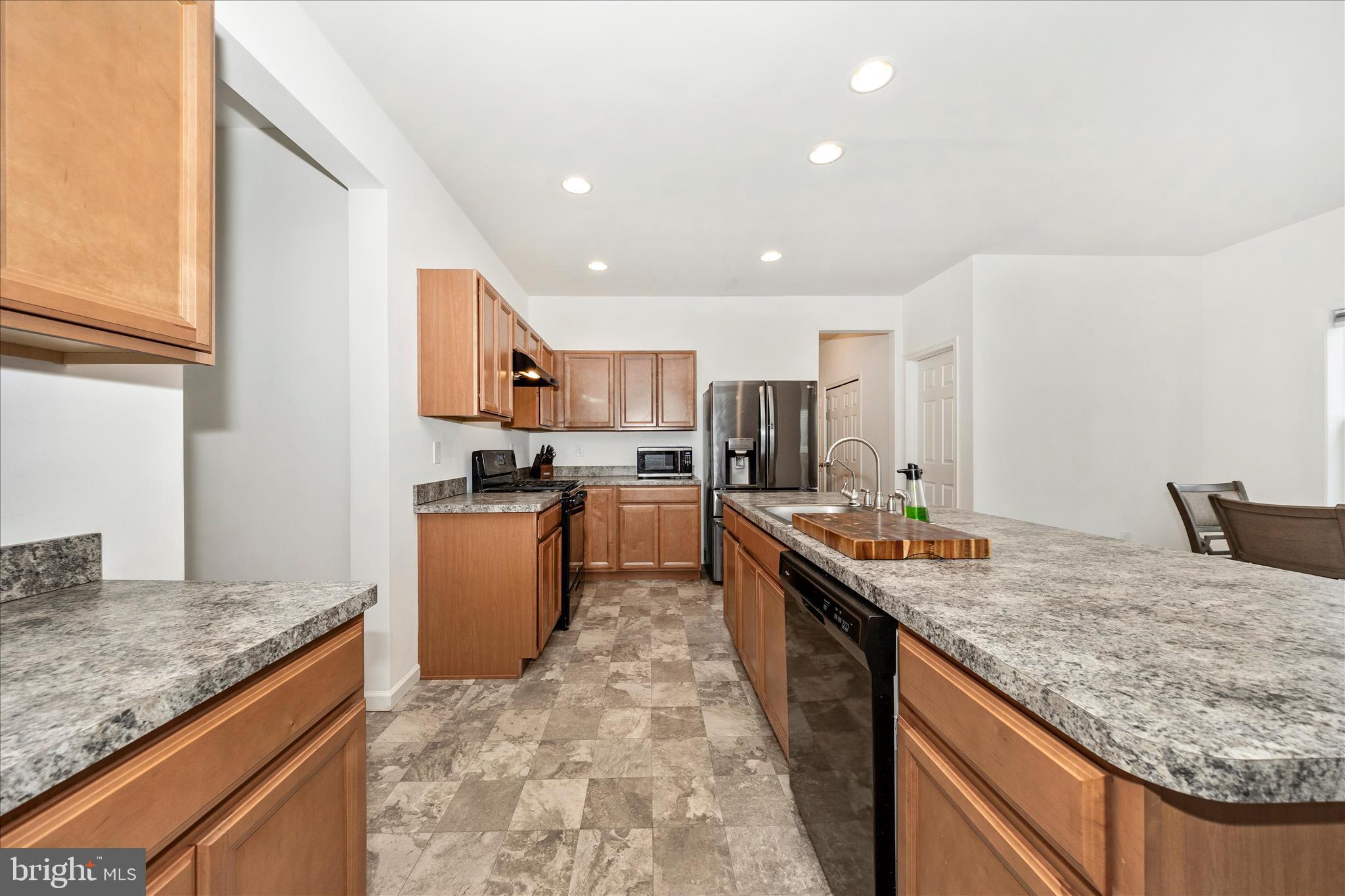 309 Eliza Road New Freedom, PA 17349 - Photo 12 of 57 a kitchen with stainless steel appliances granite countertop a sink stove and refrigerator