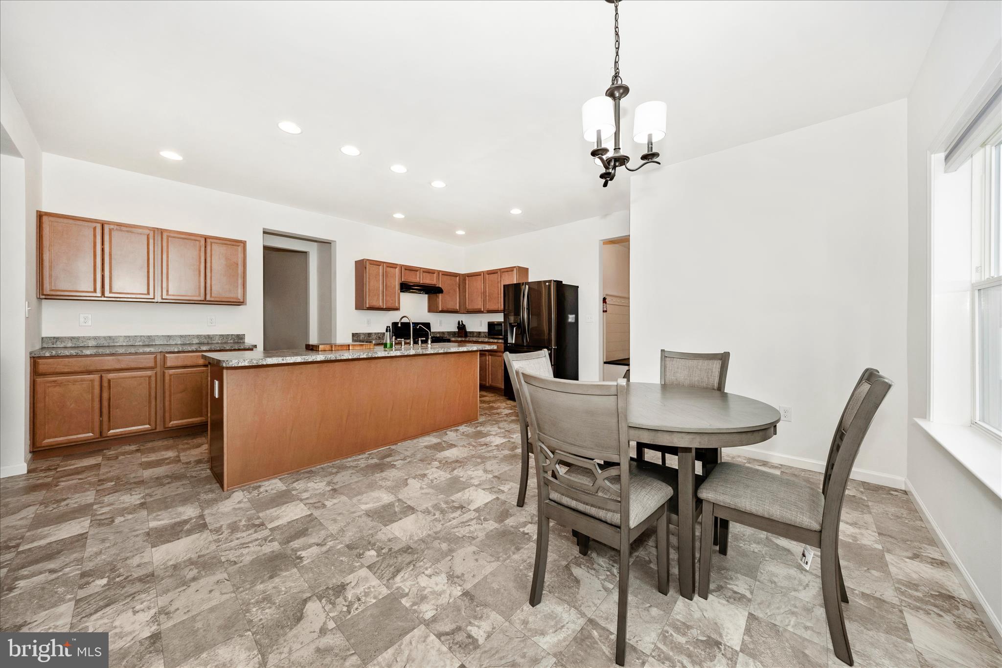 309 Eliza Road New Freedom, PA 17349 - Photo 13 of 57 a kitchen with a table chairs sink and cabinets