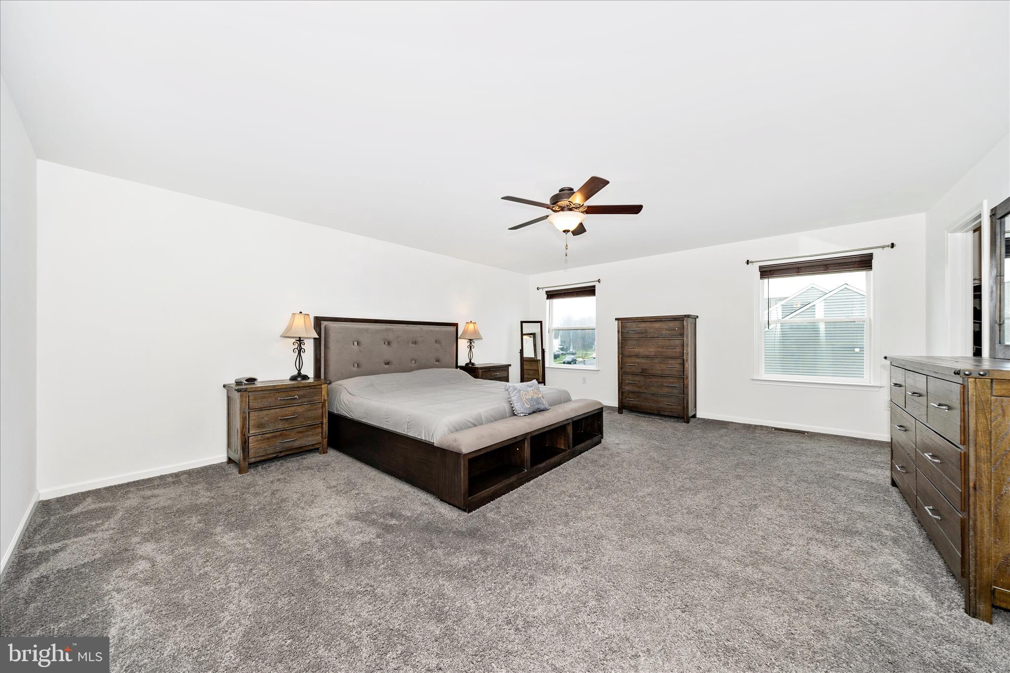 309 Eliza Road New Freedom, PA 17349 - Photo 20 of 57 a spacious bedroom with a bed and a fireplace