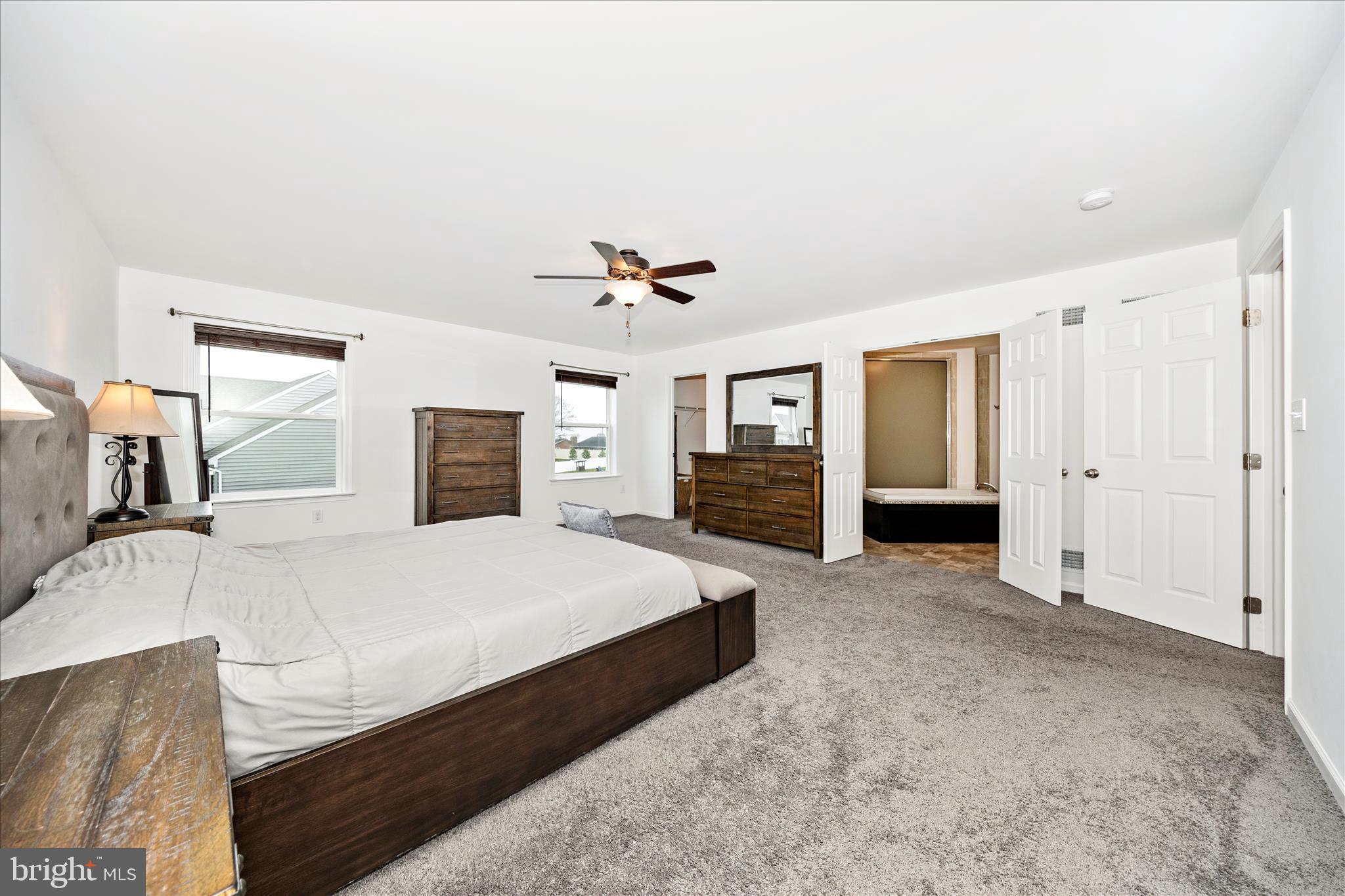 309 Eliza Road New Freedom, PA 17349 - Photo 21 of 57 a bedroom with a large bed and a chandelier