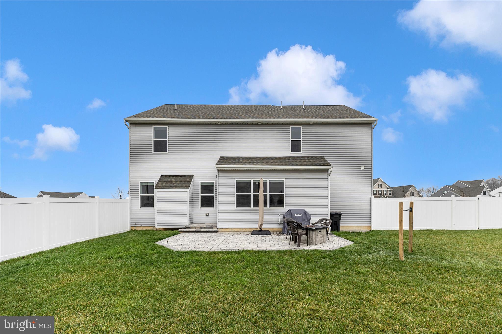 309 Eliza Road New Freedom, PA 17349 - Photo 47 of 57 a view of a white house with a big yard and a table and chairs