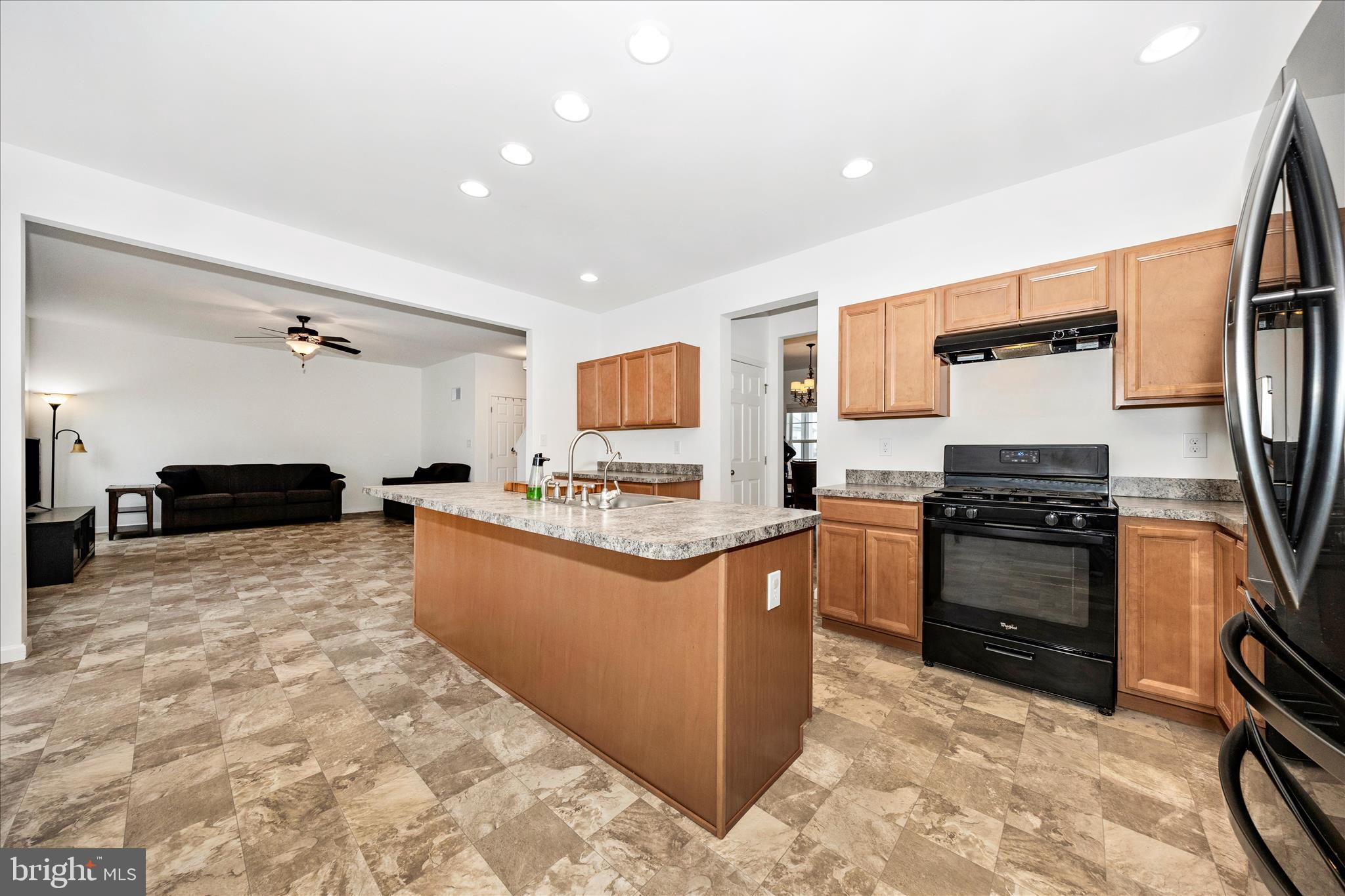 309 Eliza Road New Freedom, PA 17349 - Photo 9 of 57 a kitchen with stainless steel appliances granite countertop a stove top oven a sink a dining table and chairs
