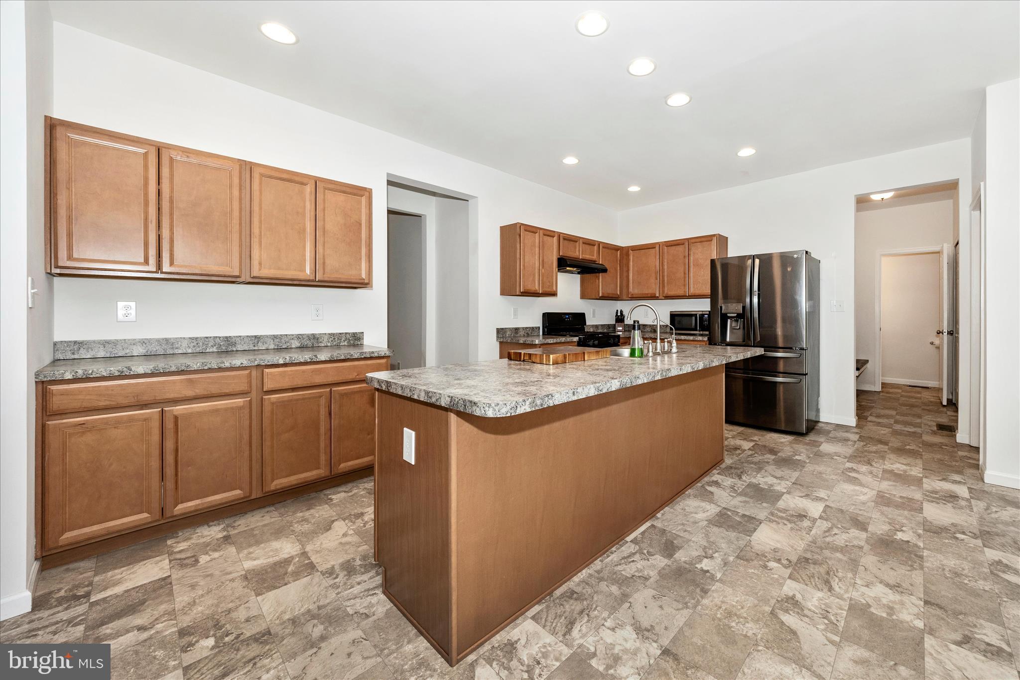 309 Eliza Road New Freedom, PA 17349 - Photo 10 of 57 a kitchen with stainless steel appliances granite countertop a refrigerator sink and cabinets