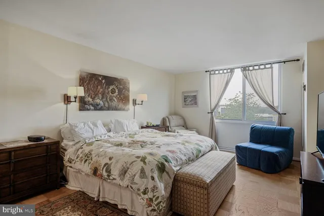 a bedroom with a bed a couch and a window