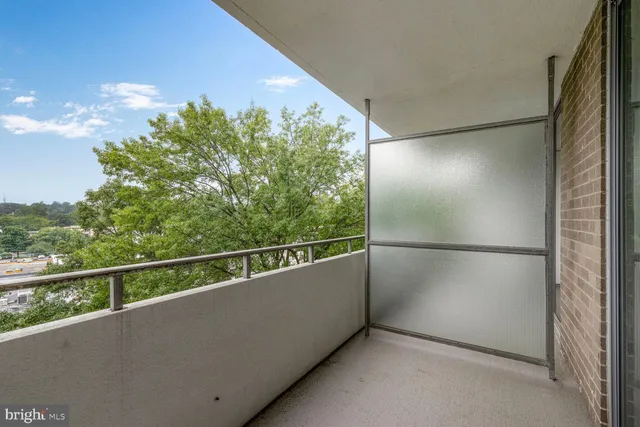 a view of a balcony with a forest