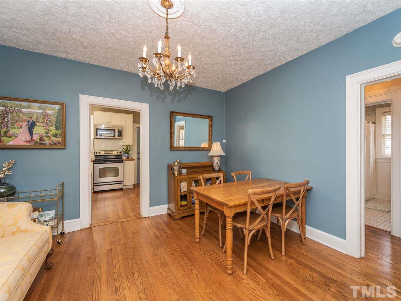 612 North Boundary Street Raleigh, NC 27604 - Photo 11 of 28 a view of a dining room with furniture wooden floor and chandelier