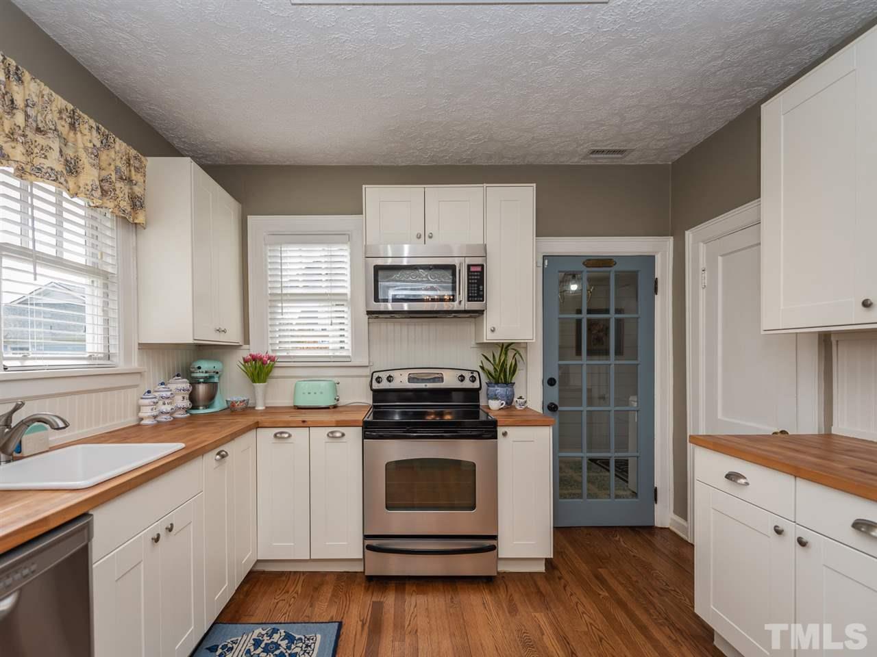 612 North Boundary Street Raleigh, NC 27604 - Photo 15 of 28 a kitchen with a stove top oven sink and cabinets