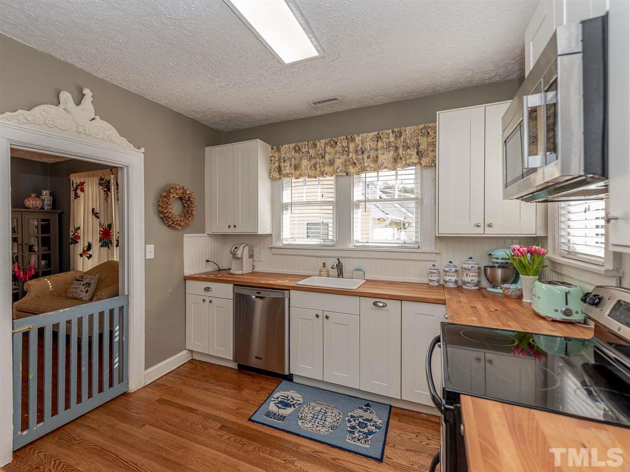 612 North Boundary Street Raleigh, NC 27604 - Photo 17 of 28 a kitchen with stainless steel appliances granite countertop a sink stove and cabinets