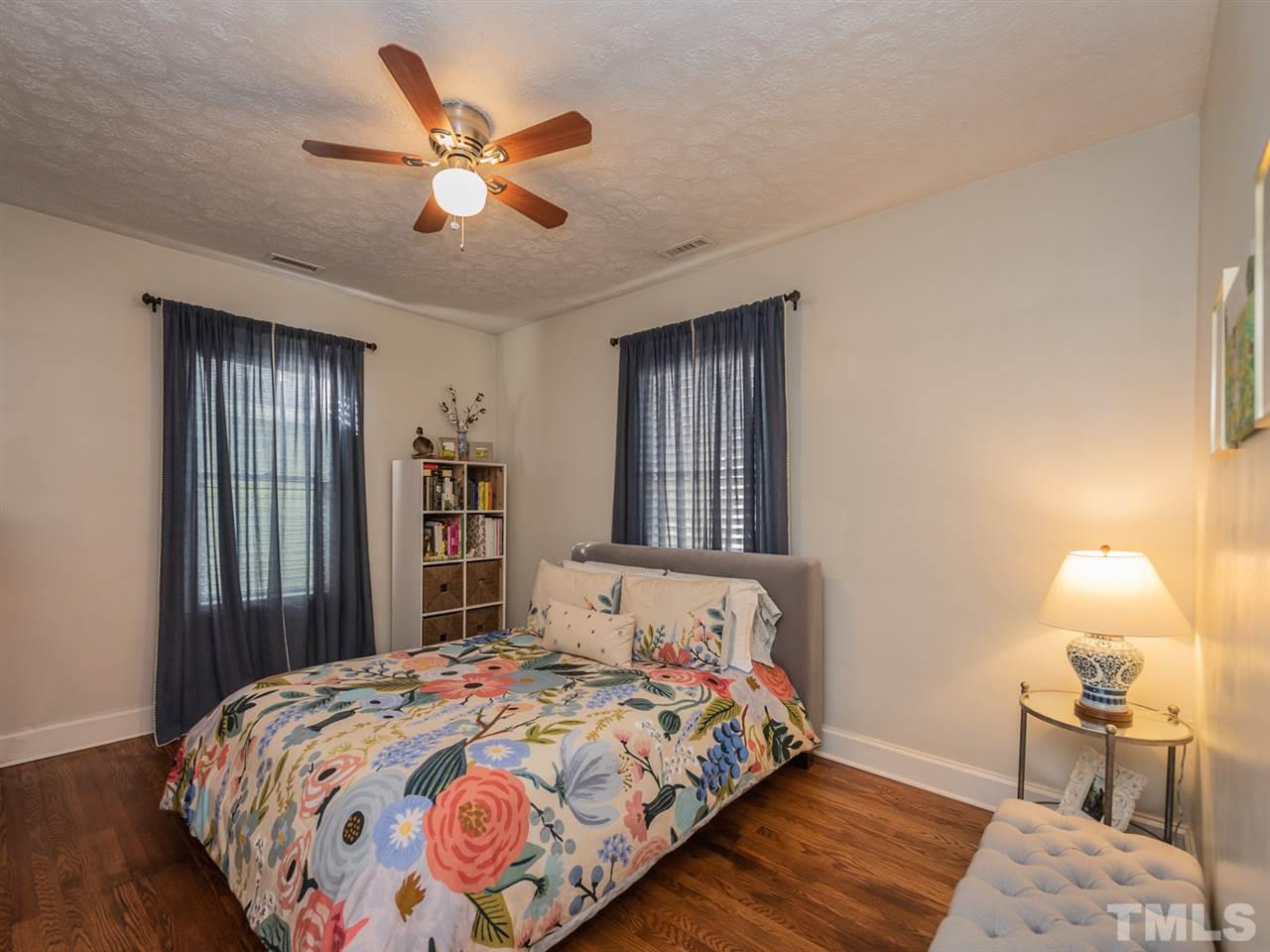612 North Boundary Street Raleigh, NC 27604 - Photo 21 of 28 a bedroom with a bed and wooden floor