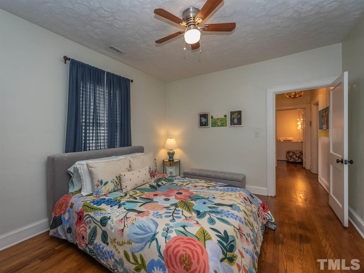 612 North Boundary Street Raleigh, NC 27604 - Photo 22 of 28 a bedroom with a bed and wooden floor