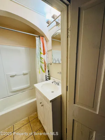 a bathroom with a sink a mirror and a bathtub