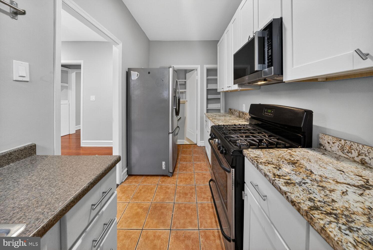 1353 Kennedy Street Northwest Washington, DC 20011 - Photo 11 of 32 a kitchen with a stove and a refrigerator