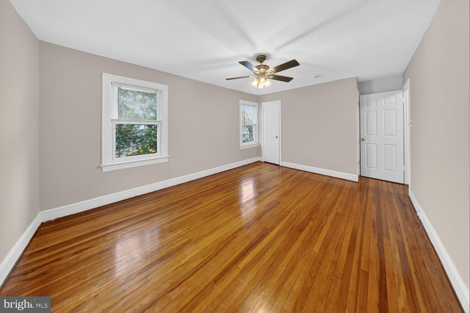 1353 Kennedy Street Northwest Washington, DC 20011 - Photo 13 of 32 a view of an empty room with wooden floor and a chandelier fan