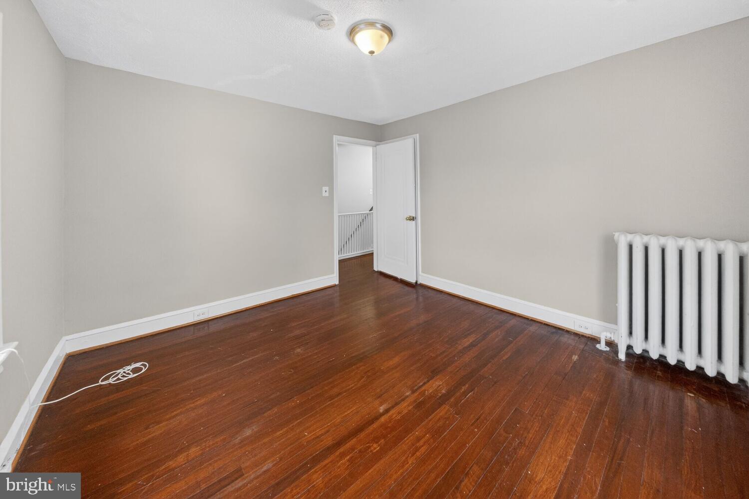 1353 Kennedy Street Northwest Washington, DC 20011 - Photo 15 of 32 an empty room with wooden floor and windows
