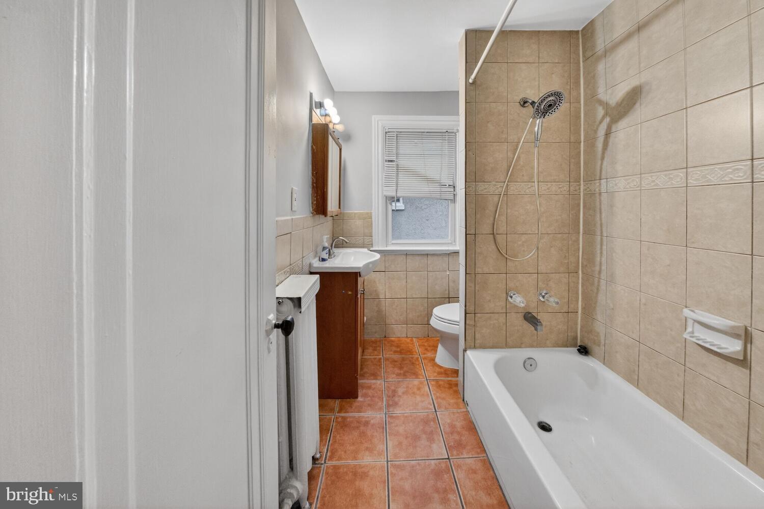 1353 Kennedy Street Northwest Washington, DC 20011 - Photo 19 of 32 a bathroom with a tub a sink and a shower