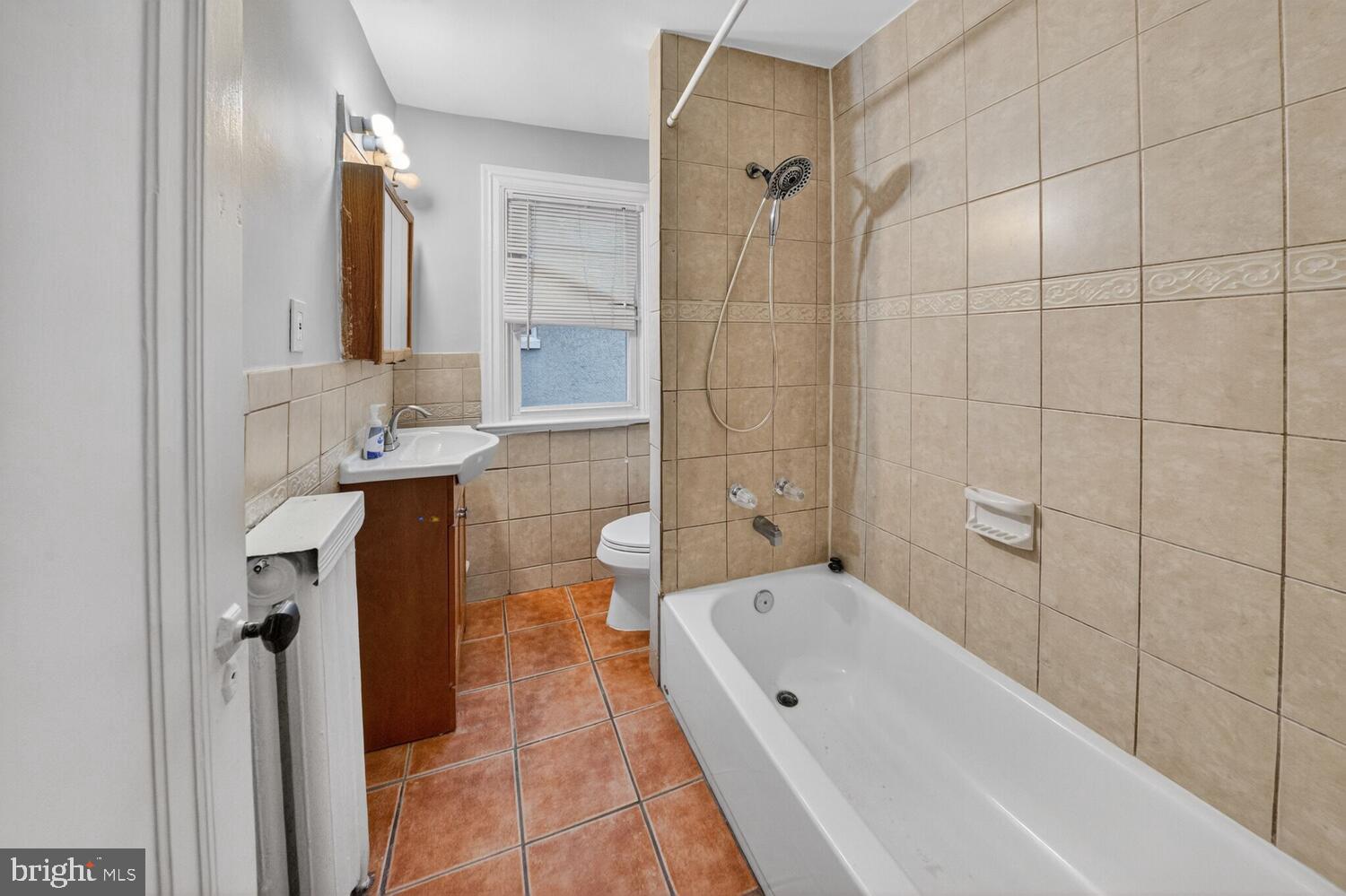 1353 Kennedy Street Northwest Washington, DC 20011 - Photo 20 of 32 a bathroom with a tub sink shower and mirror