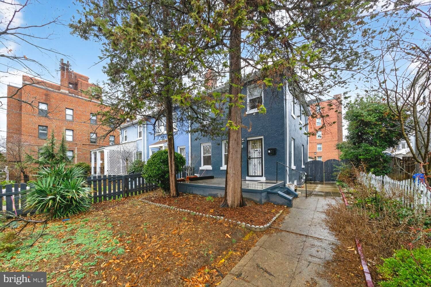 1353 Kennedy Street Northwest Washington, DC 20011 - Photo 2 of 32 a front view of a house with a garden