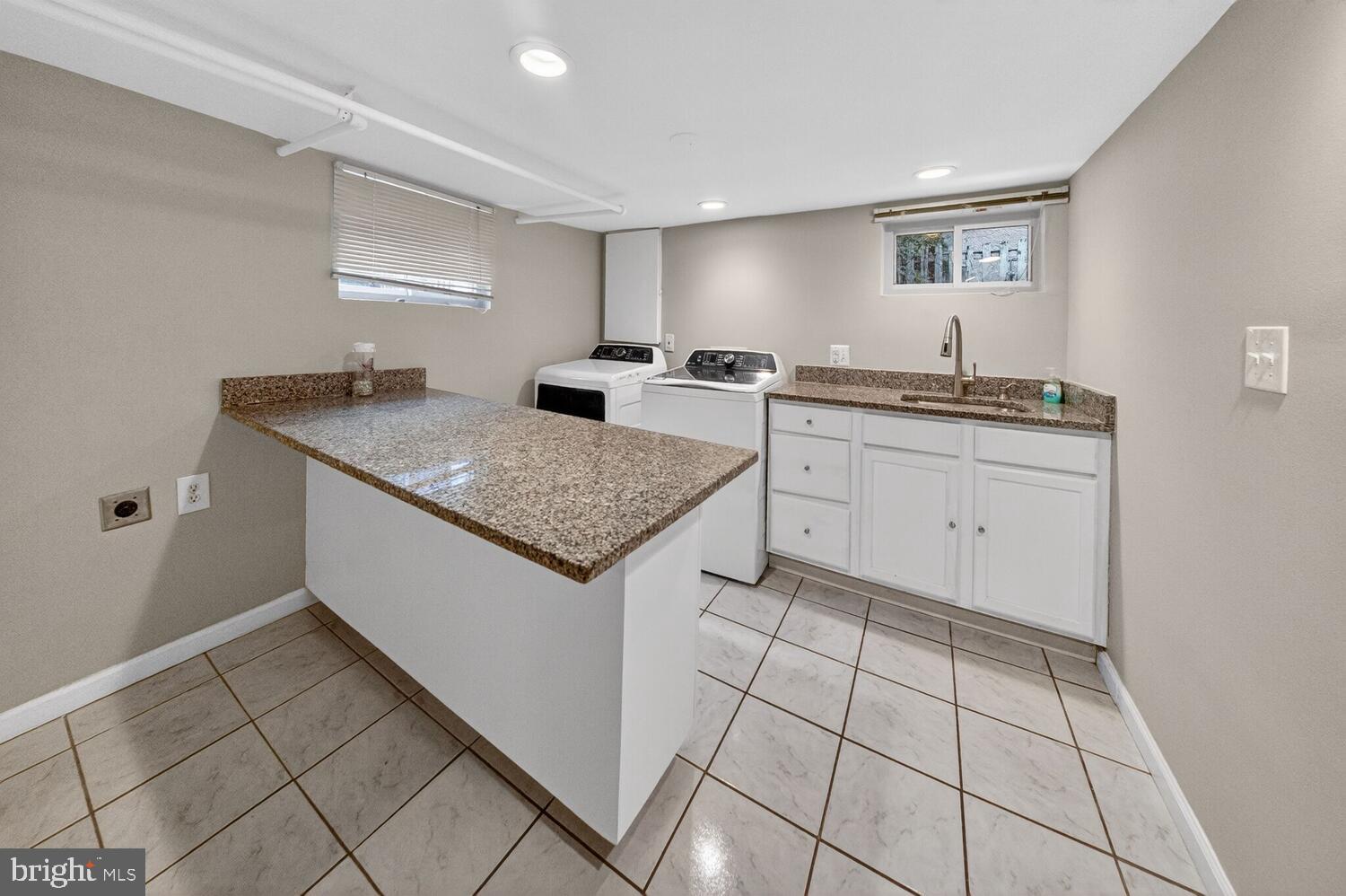 1353 Kennedy Street Northwest Washington, DC 20011 - Photo 24 of 32 a kitchen with sink cabinets and stove