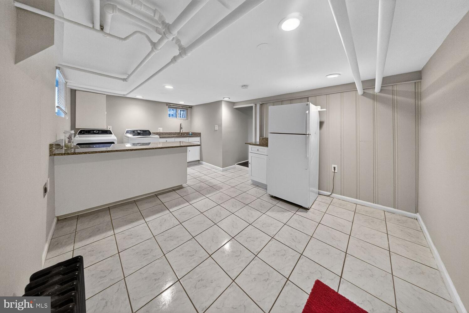 1353 Kennedy Street Northwest Washington, DC 20011 - Photo 25 of 32 a kitchen with stainless steel appliances a sink stove and cabinets