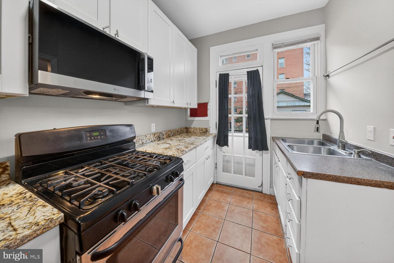 1353 Kennedy Street Northwest Washington, DC 20011 - Photo 9 of 32 a kitchen with a stove and a microwave