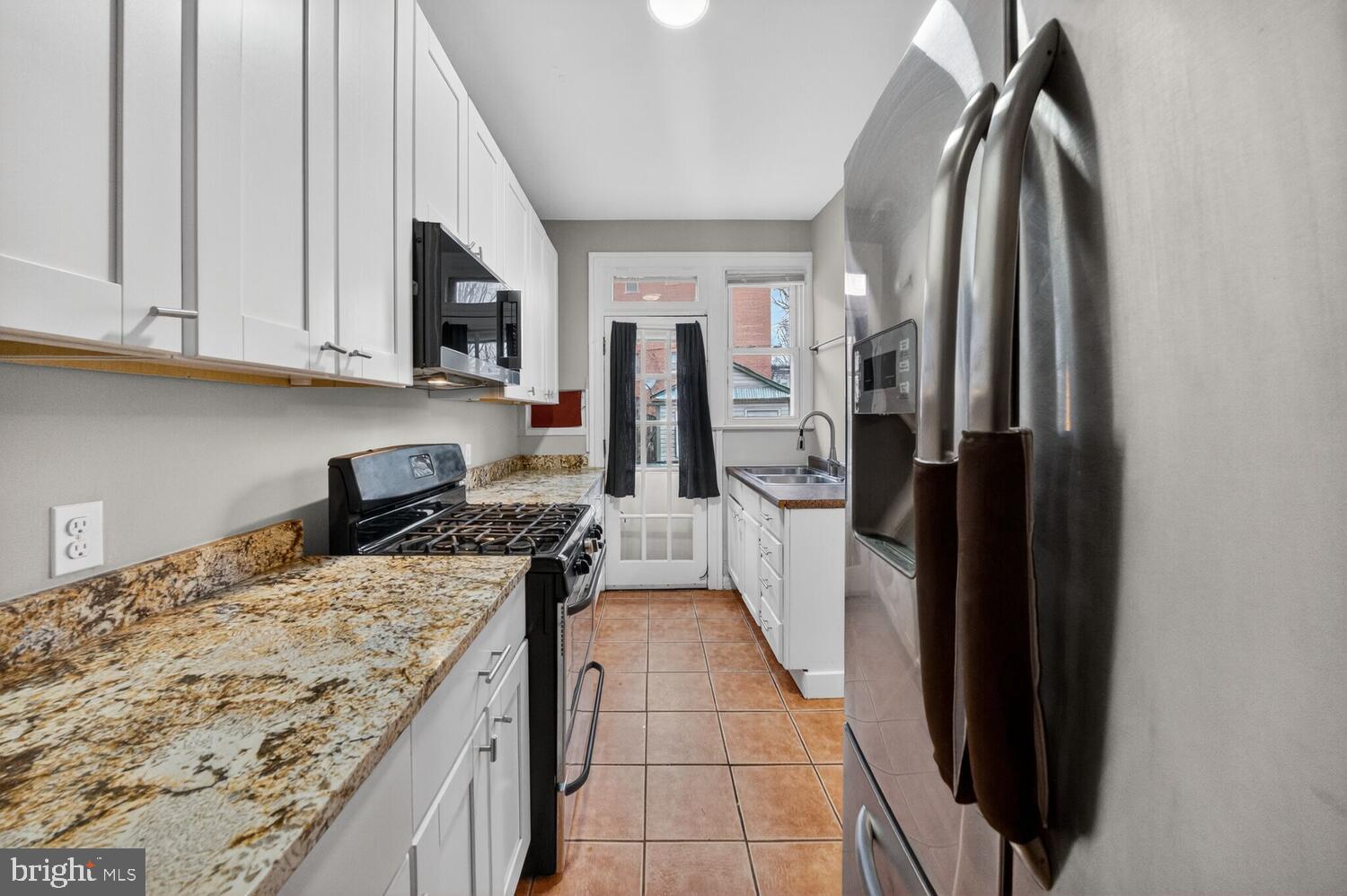 1353 Kennedy Street Northwest Washington, DC 20011 - Photo 10 of 32 a kitchen with stainless steel appliances granite countertop a refrigerator and a stove