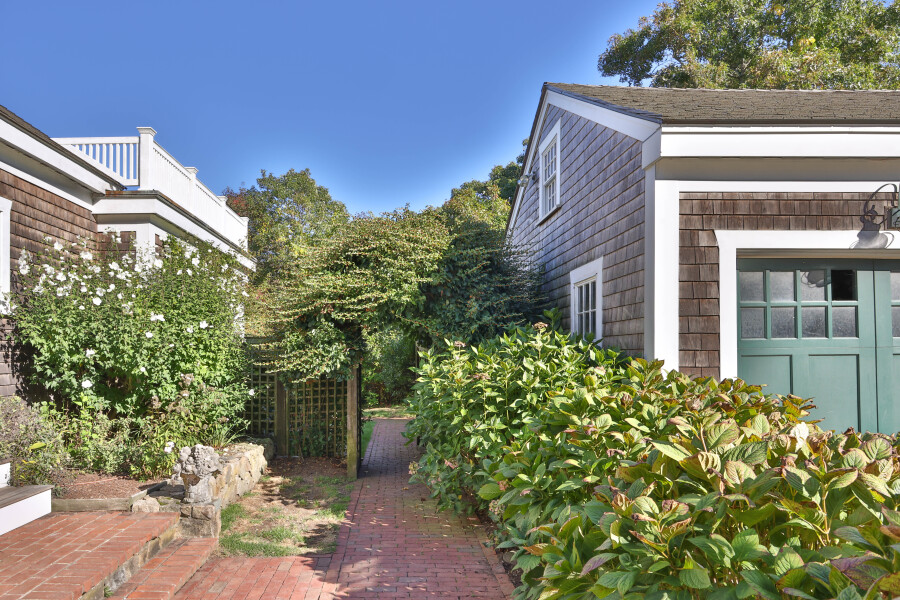 9 Fowler Avenue Edgartown, MA 02539 - Photo 3 of 27 a front view of a house with a garden
