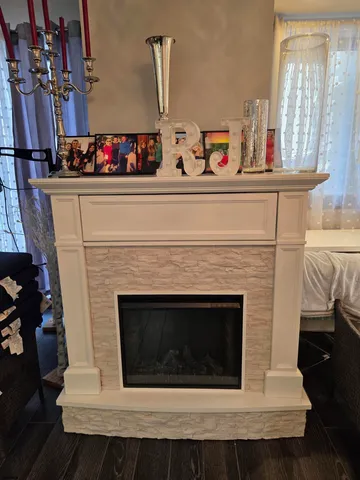 a living room with a fireplace and furniture