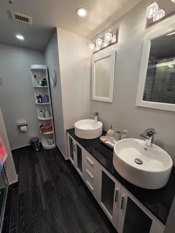 a bathroom with a double vanity sink and a mirror
