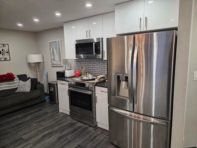 a kitchen with stainless steel appliances a refrigerator stove and microwave