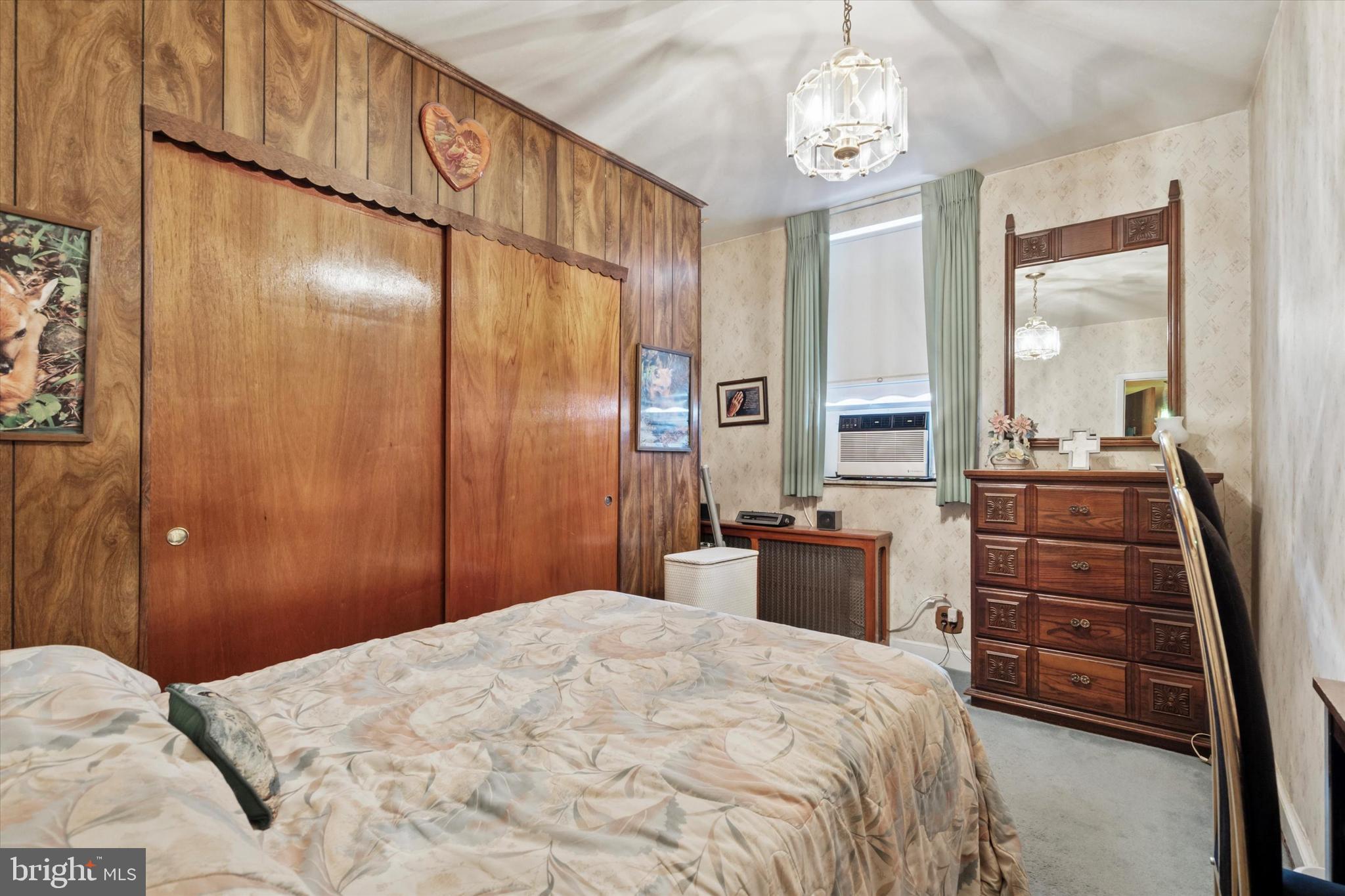 1637 West Ritner Street Philadelphia, PA 19145 - Photo 11 of 15 a bedroom with a bed and a chandelier