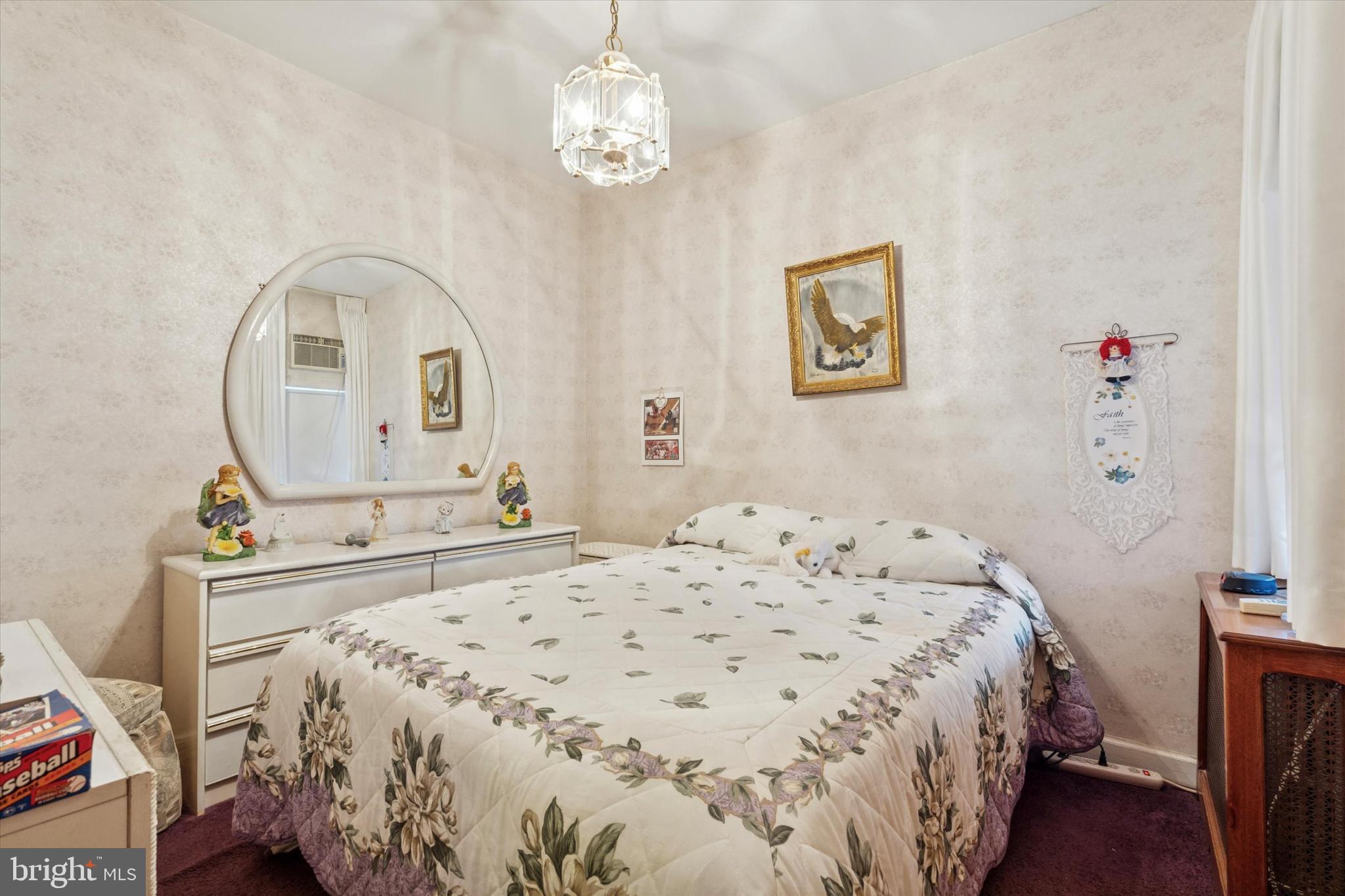 1637 West Ritner Street Philadelphia, PA 19145 - Photo 14 of 15 a bedroom with a bed and a chandelier