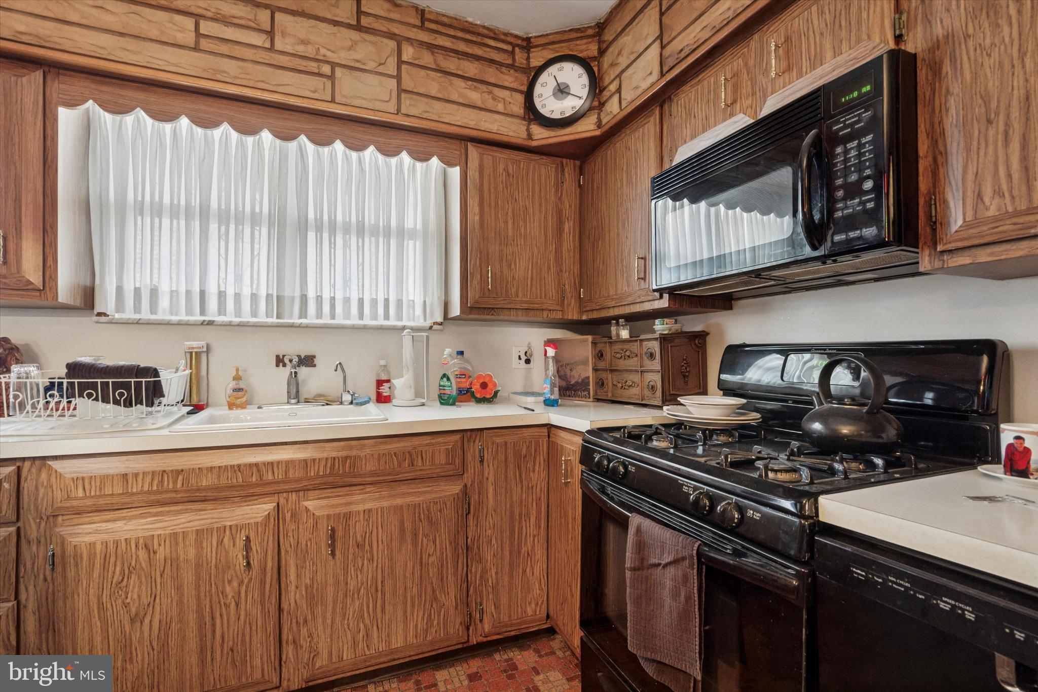 1637 West Ritner Street Philadelphia, PA 19145 - Photo 6 of 15 a kitchen with stainless steel appliances granite countertop a stove a sink a refrigerator and cabinets
