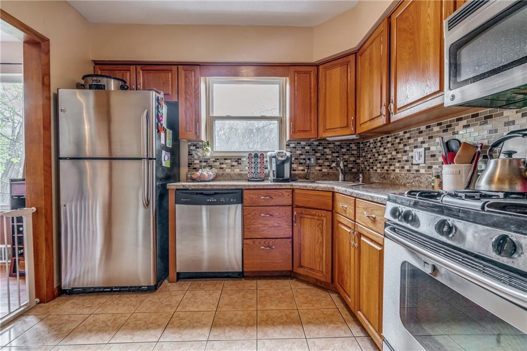 6 Virginia Terrace Pittsburgh, PA 15229 - Photo 11 of 23 a kitchen with a white stove top oven and refrigerator
