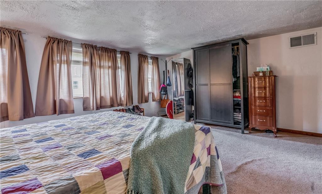 6 Virginia Terrace Pittsburgh, PA 15229 - Photo 13 of 23 a bed sitting in a spacious bedroom next to a window and a mirror