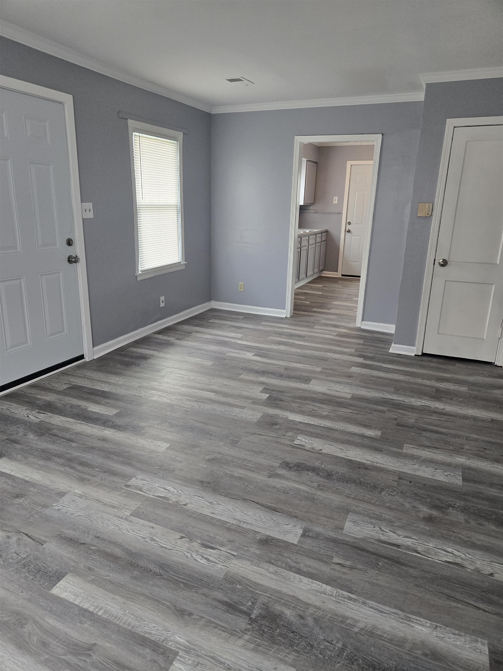 4753 Berta Road Memphis, TN 38109 - Photo 7 of 15 a view of empty room with window and wooden floor