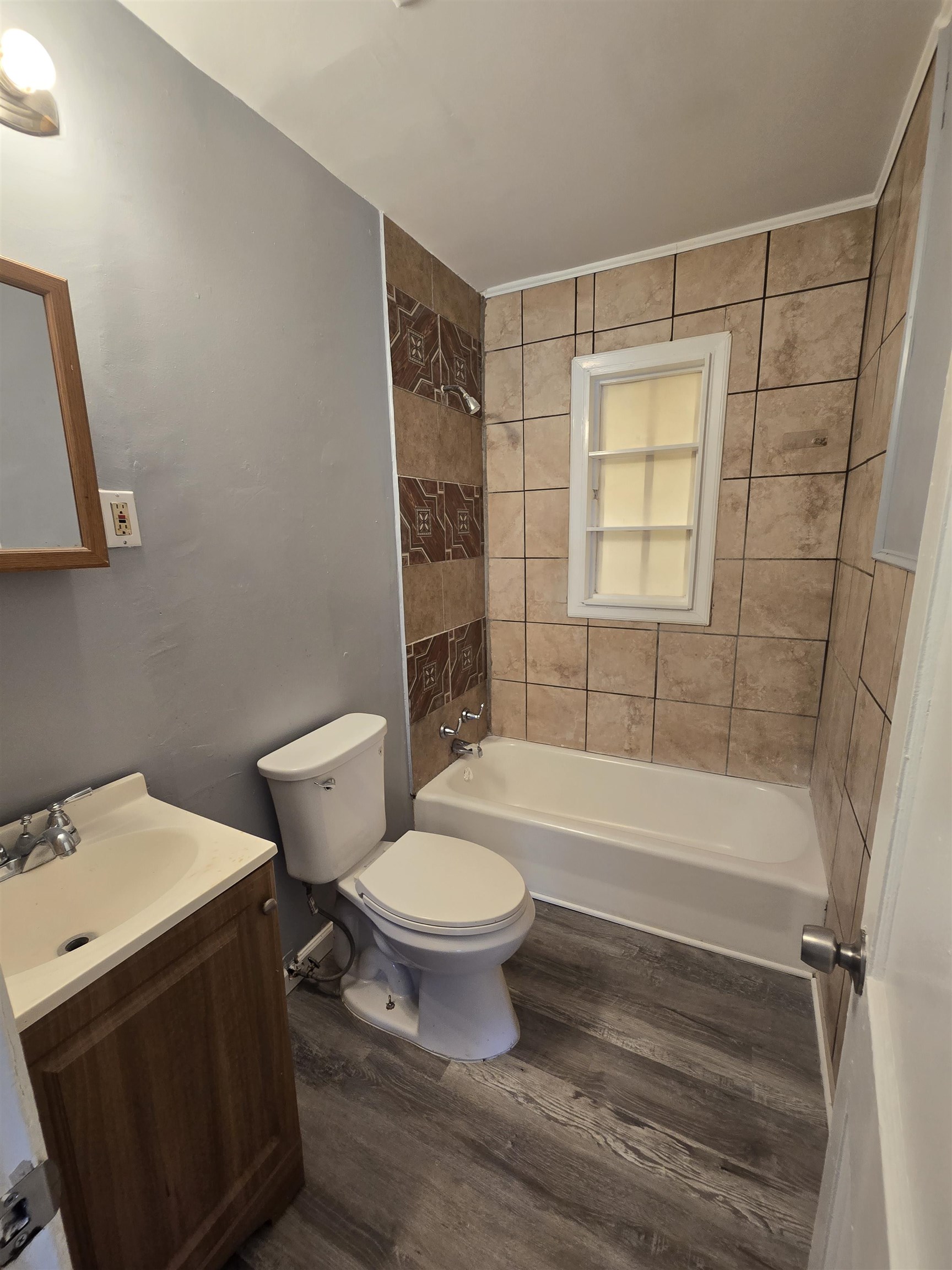 4753 Berta Road Memphis, TN 38109 - Photo 10 of 15 a bathroom with a sink toilet and shower