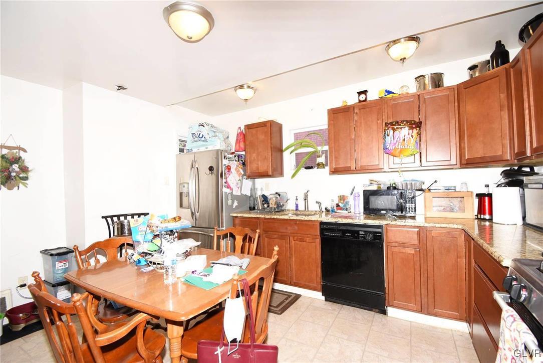 121 Main Street Hellertown, PA 18055 - Photo 11 of 29 a kitchen with stainless steel appliances kitchen island granite countertop a sink and cabinets
