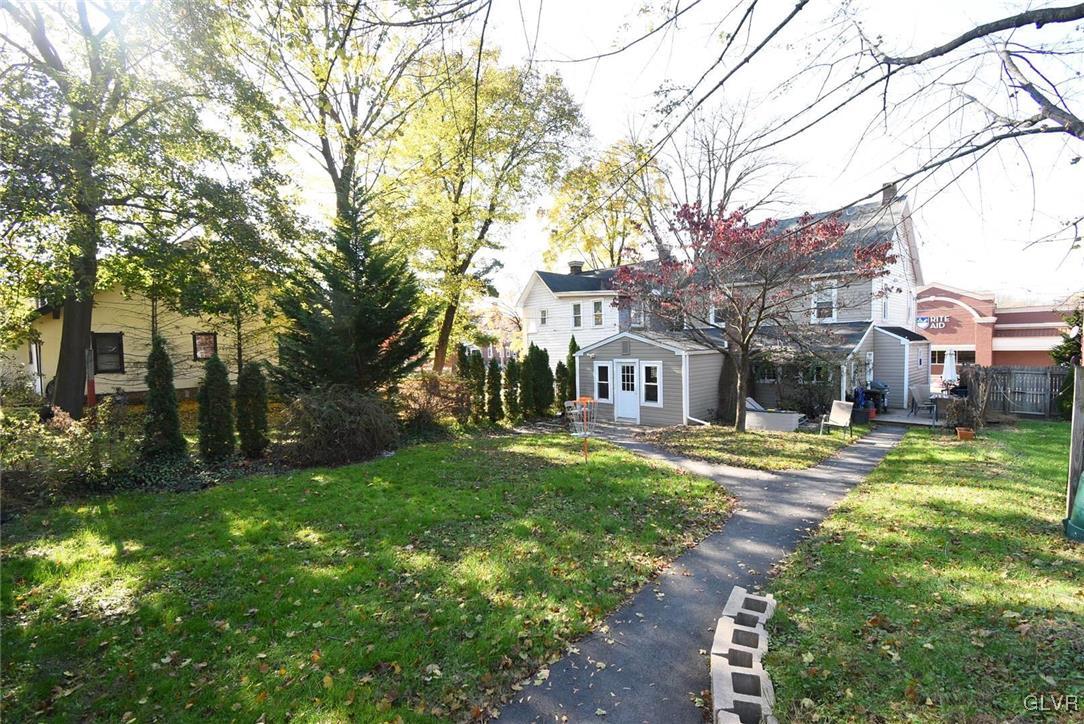 121 Main Street Hellertown, PA 18055 - Photo 21 of 29 a brick house with trees in front of it