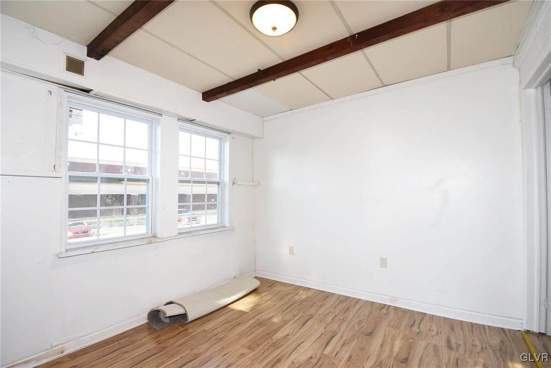 121 Main Street Hellertown, PA 18055 - Photo 5 of 29 an empty room with wooden floor and windows