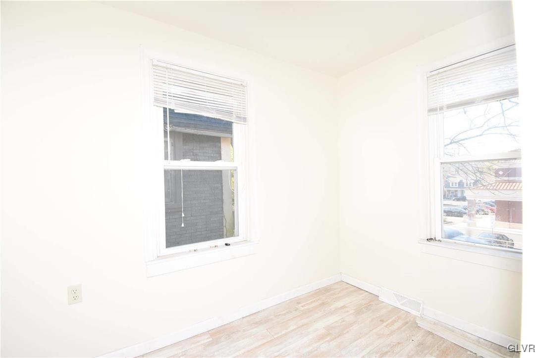 121 Main Street Hellertown, PA 18055 - Photo 7 of 29 a view of an empty room with wooden floor and a window